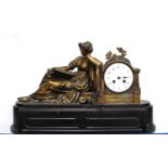 19th century mantel clock with gilt classical figure reclining reading a book, white enamelled face,