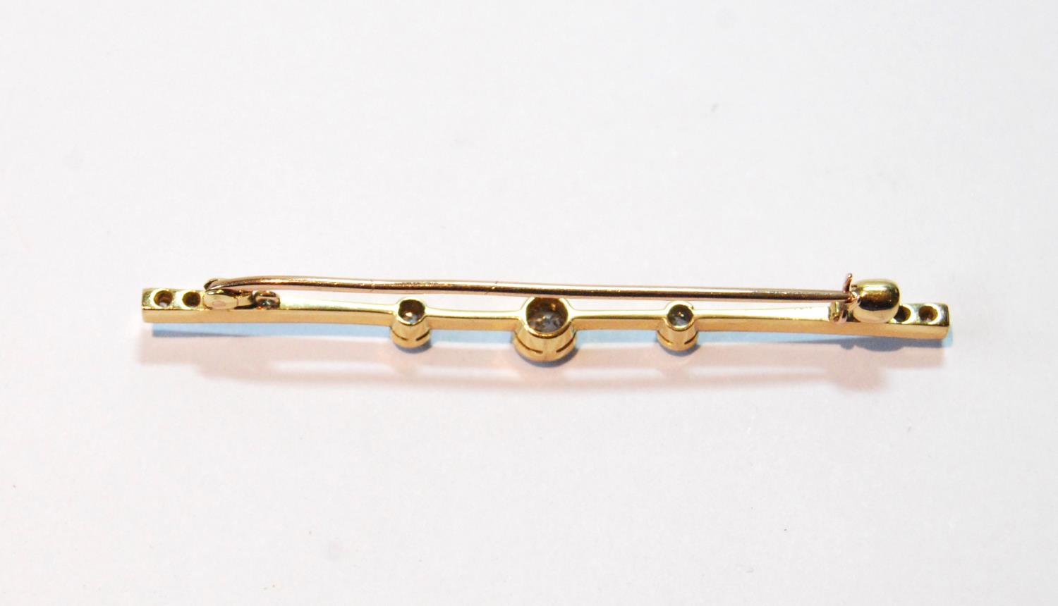 Diamond bar brooch with three millegrain-set brilliants, and two others, smaller, at each end, - Image 2 of 2