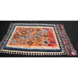 Kilim rug with diamond pattern over faded red ground, and border, 215cm x 144cm.