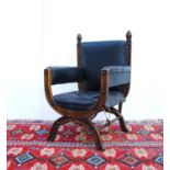 Bishop's X-frame armchair with mitre finials, cushioned back and open arms, stuff-over seat,