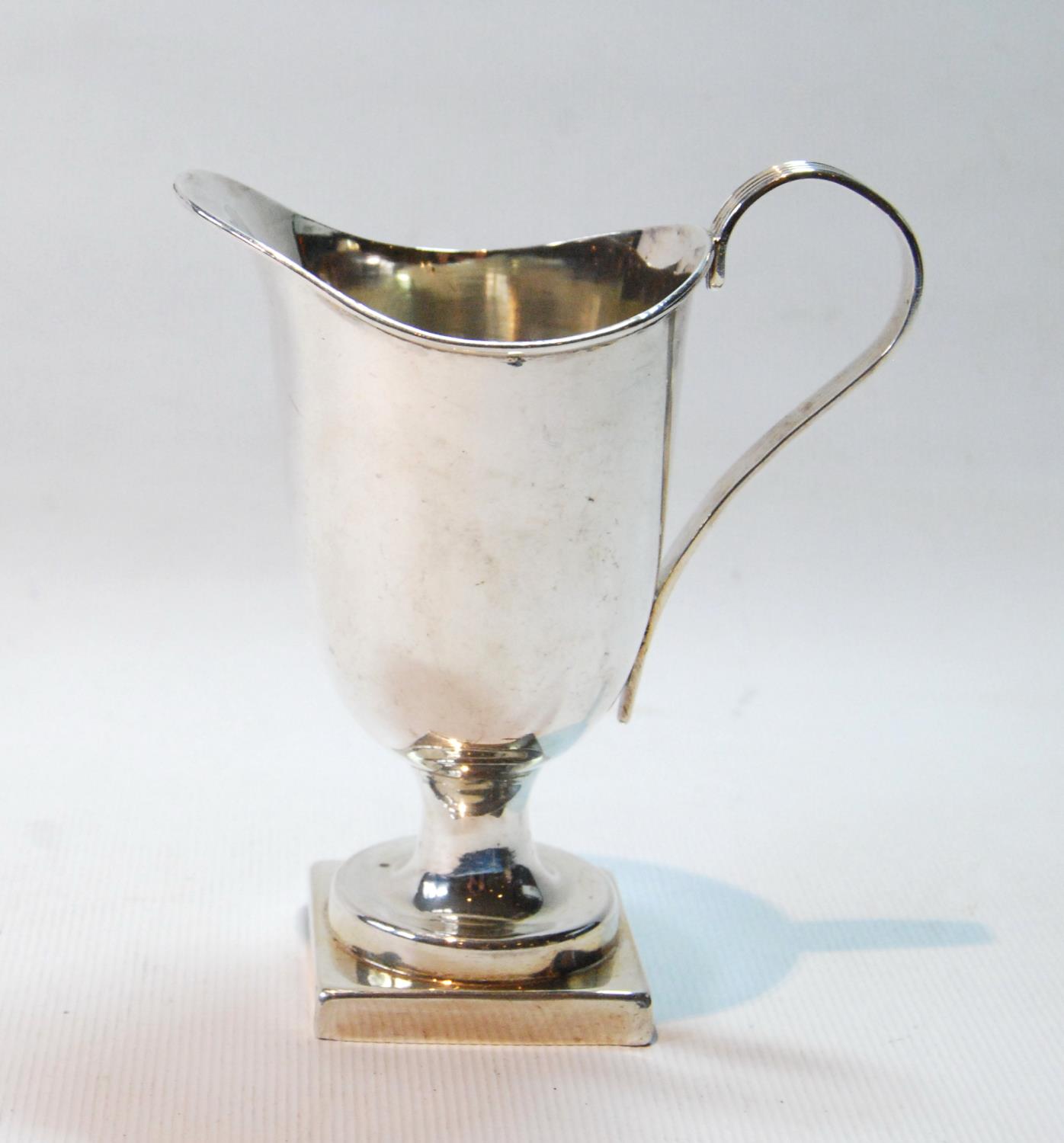 Silver cream jug of late 18th century helmet shape on square foot, by W. Deakin, Birmingham 1897,