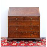 Late 19th century oak bureau with moulded fall flap enclosing fitted interior over two short and