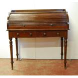 Edwardian oak roll-top desk with three-quarter gallery over tambour front enclosing fitted interior,