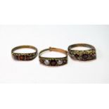 Three garnet rings, in 9ct gold, 7g gross.