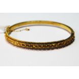 Victorian gold hinged bangle, probably 15ct, 8.8g.