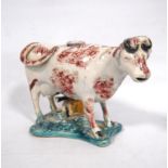 19th century style English spongeware cow creamer with burgundy decoration, milk maid, and later