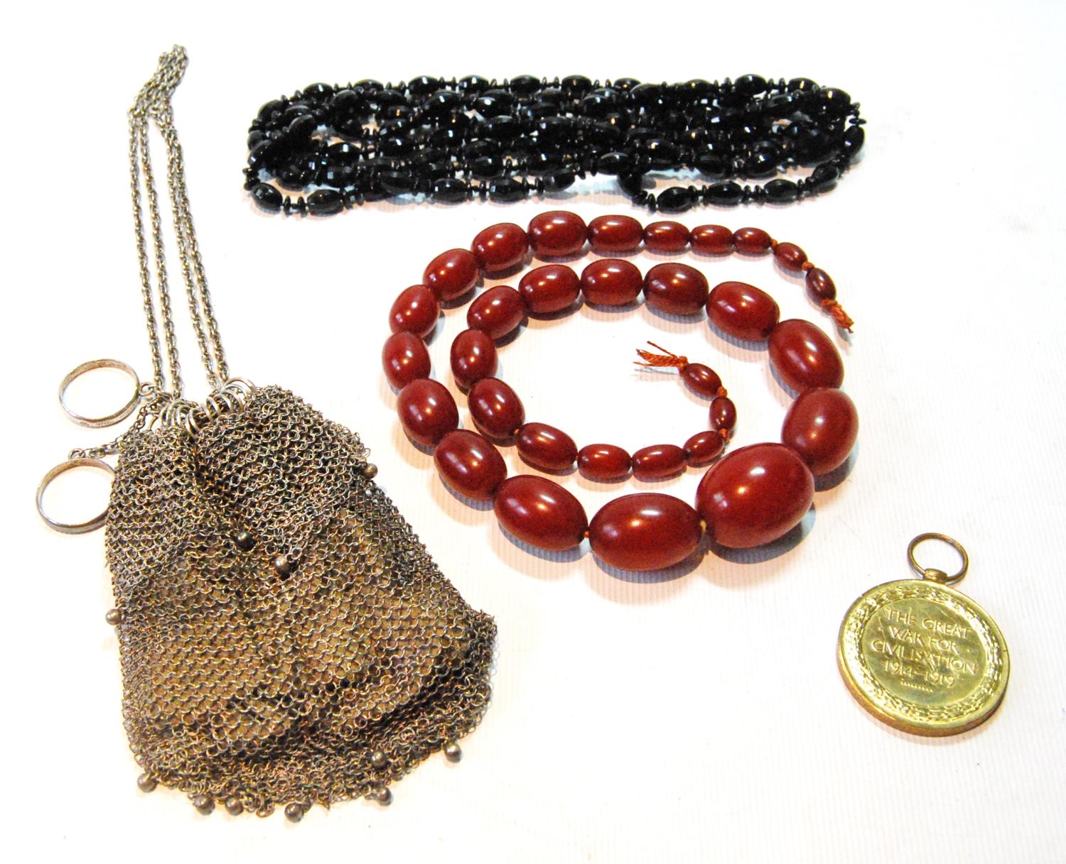 Silver mesh purse, a Great War bronze medal, and two bead necklets.