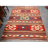 Kilim rug with cruciform and stripe design, 334cm x 165cm.