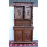 Edwardian oak court cupboard, the inverted projected moulded cornice over frieze panel, acanthus