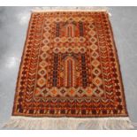 Persian rug with two panels, simple mihrab, faded red ground, rosettes, and border, 150cm x 109cm.