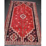 Rug with central medallion, simple tree design over red ground, spandrels, and triple border,