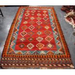 Kilim with four rows of eight diamonds over red ground, and triple border, 290cm x 160cm.