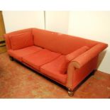 Large sofa with cushioned back and scroll arms, loose cushioned seat, raised on turned legs, 225cm
