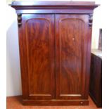 Victorian mahogany two-door wardrobe, the projected cornice over panelled doors enclosing drawers