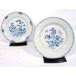 Two Chien Lung blue and white plates, each decorated with chrysanthemums, with stands, 23cm