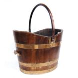 Brass-bound coal bucket of tapering oval form with swing handle, 37cm wide, 28cm high, and 30cm