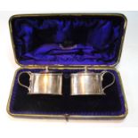 Pair of silver oval mustard pots, by Jackson & Fullerton 1897, 5½oz, cased.