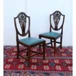 Set of eight mahogany dining chairs of George III design, each with moulded shield-shaped back, with