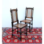 Set of four Charles II style oak side chairs, each with floral carved top rail, caned back and seat,