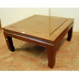 Oriental hardwood occasional table with square panelled top, raised on square legs and spade feet,