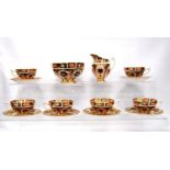 Royal Crown Derby part tea service comprising twelve tea cups, twelve saucers, twelve side plates,