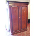 Edwardian walnut two-door wardrobe, the dentil projected cornice above panelled doors enclosing