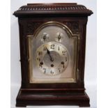 Mahogany cased bracket clock, the gadrooned pediment over metal arched face, applied chapter ring,