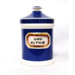 Apothecary jar and lid with blue glaze and central plaque, 'UNG : ALTHÆ', 23cm high.