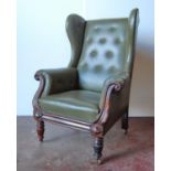 19th century mahogany wing back armchair with scroll-carved arms, raised on baluster legs