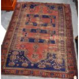 Persian rug with two central panels over red ground, opposing mihrab, rosettes, and triple border,