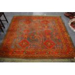 Turkish carpet, rosette and floral design, faded blue and red ground, and border, 214cm x 200cm.