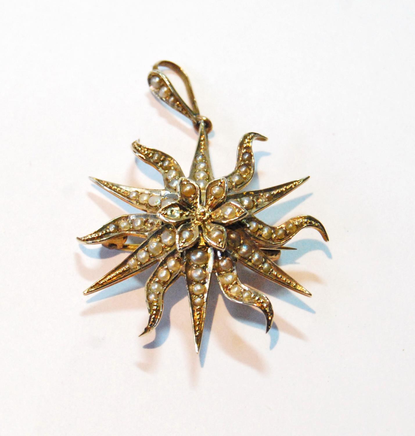 Starburst brooch/pendant with wavy rays set with pearls, '9ct', three pearls missing, 5.7g.