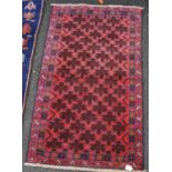 Small rug with all over rosette pattern, red ground, and double border, 140cm x 82cm.