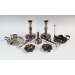 A collection of early 20th century and later silver plated wares comprising: a pair of candlesticks,