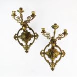 A pair of three arm gilt brass wall mounted girandoles, probably 19th century, the florally