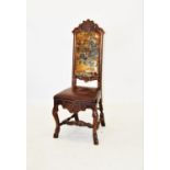 A late 17th century oak hall chair, possibly Dutch, the crescent shaped top rail carved with blue