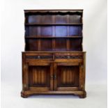An 18th century style oak Welsh dresser, mid 20th century, the high back with two enclosed