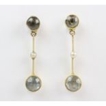 A pair of Edwardian aquamarine and seed pearl set drop earrings, each comprising a round mixed cut