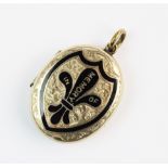 A Victorian enamelled memorial locket pendant, the yellow metal oval shaped pendant with black