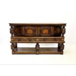 A 17th century style oak buffet sideboard, with an arrangement of two cupboard doors and two drawers