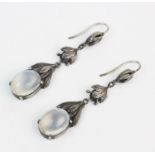 A pair of Arts & Crafts style moonstone set drop earrings, each comprising an oval moonstone