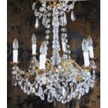 A French gilt metal and crystal chandelier, the central baluster shaped column extending to an upper