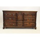 A George III oak Lancashire mule chest, the rectangular hinged lid above a central fielded panel and