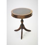 A Regency style mahogany drum table, with a leather inset top, above two frieze drawers, raised upon