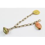 A yellow metal bracelet with assorted charms, the mixed link bracelet stamped '9ct' measuring