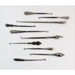 A selection of silver and silver coloured button hooks, to include; a George V silver button hook,