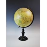 A John Heywood Ltd desktop globe on stand, late 19th century, the globe mounted on a brass half