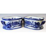 A pair of Victoria ware blue and white foot baths, each transfer decorated with architectural