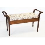 An Edwardian mahogany duet stool, the rectangular upholstered seat flanked by turned hand rails,