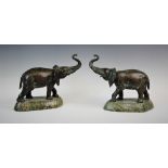 A pair of bronze elephant figures, late 20th century, modelled standing with head and trunk